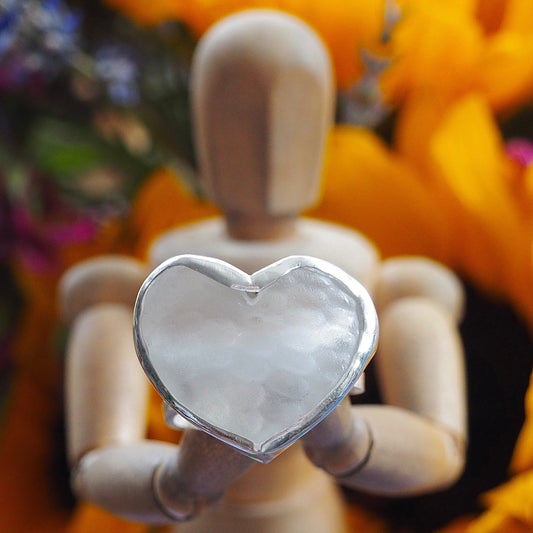 A simple unique heart ring with ‘sea glass’ from an upcycled Mermaid gin bottle set in recycled sterling silver on an adjustable band.