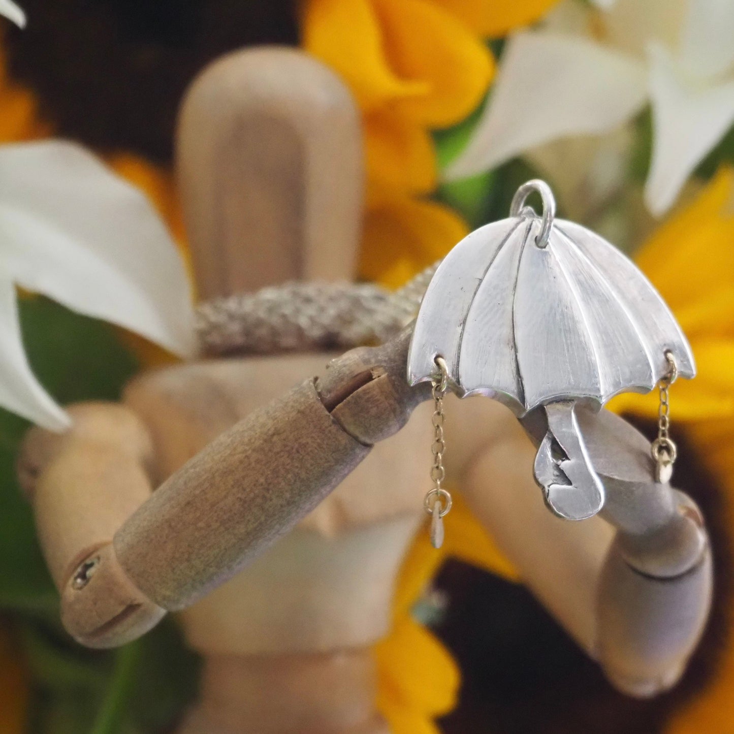 A beautiful unique fine silver flamingo umbrella necklace with tiny gold rain drops.