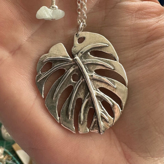 A gorgeous unique large monstera leaf handmade in eco friendly fine silver hung on a sterling silver necklace.