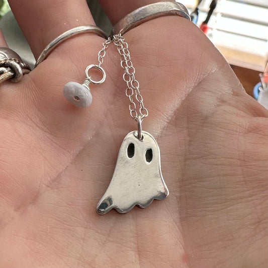 A cute little ghost pendant handmade in fine silver on a sterling silver chain.