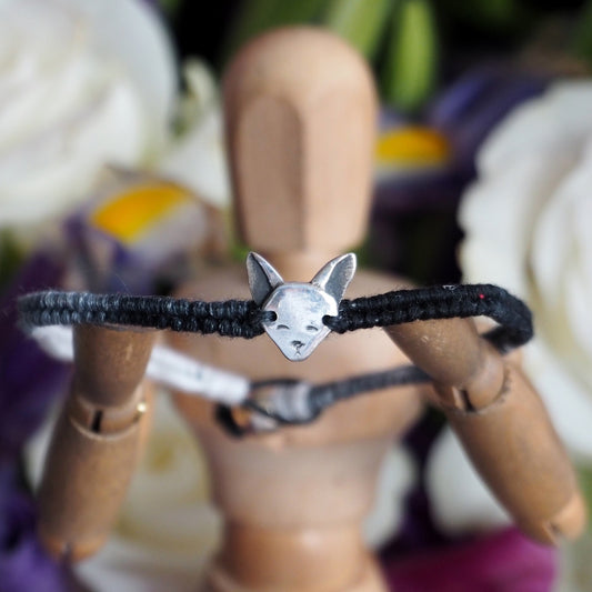 A wonderful grey and black leather, sterling silver and cotton friendship bracelet with a tiny unique fine silver Siamese cat.