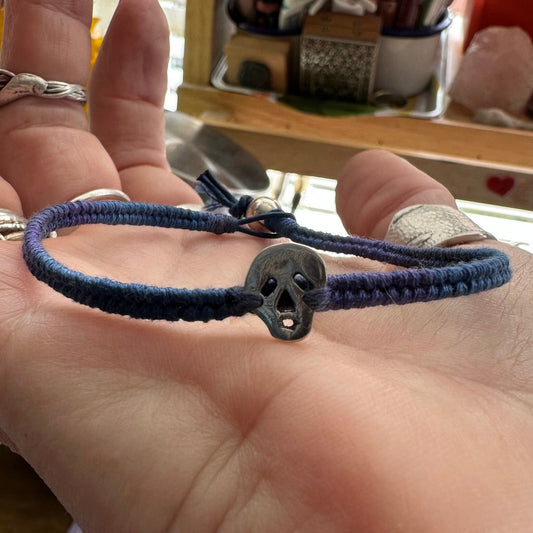 A wonderfully gothic tiny unique fine silver skull on a blues and purples leather, sterling silver and cotton friendship bracelet.