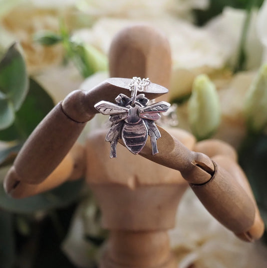 A charming unique honey bee pendant hand made in fine silver on a sterling silver chain.