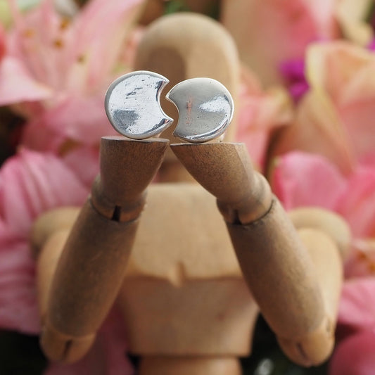 A stunning pair of tiny fine silver moon stud earrings on sterling silver posts.