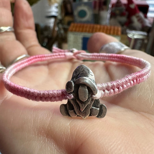 A handmade fine silver Norm nisse gnome on a pretty pink leather and cotton friendship bracelet, finished with a sterling silver bead.