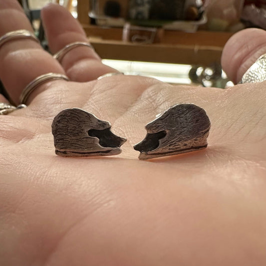 A lovely pair of tiny handmade fine silver hedgehog stud earrings set on sterling silver pins.