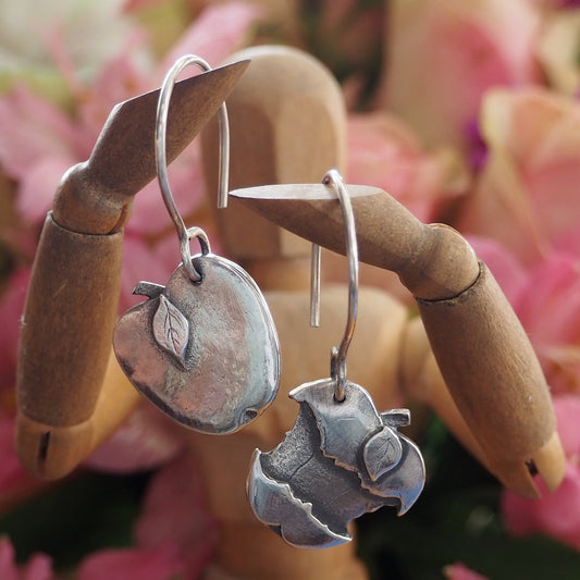 A wonderfully simple pair of handmade solid silver apple and core earrings hung on sterling silver hooks.