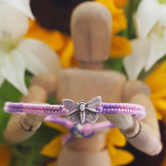 A lovely fine silver butterfly on a beautiful pinky purple leather, cotton and sterling silver friendship bracelet.