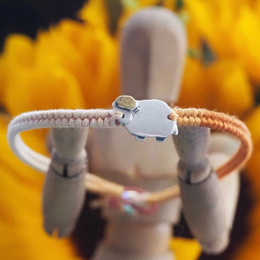 An adorable little sheep handmade in fine silver and gold on a yellows and orange leather, cotton and sterling silver friendship bracelet.