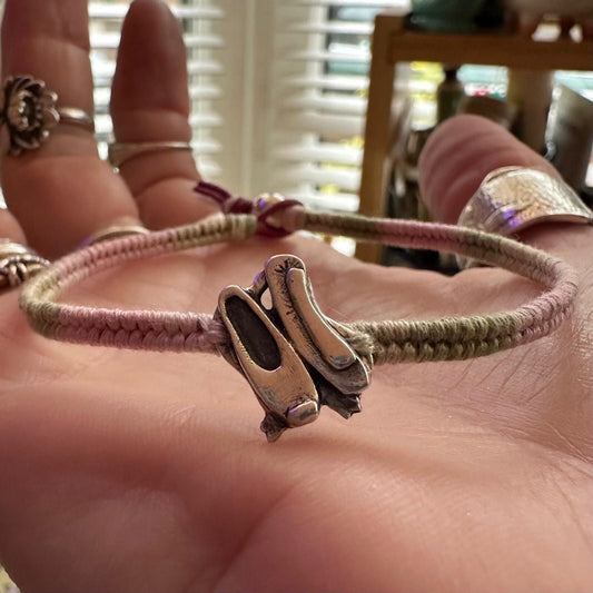 A beautiful pair of ballet shoes handmade in fine silver on a pinks and greens leather, sterling silver and cotton woven charm bracelet…