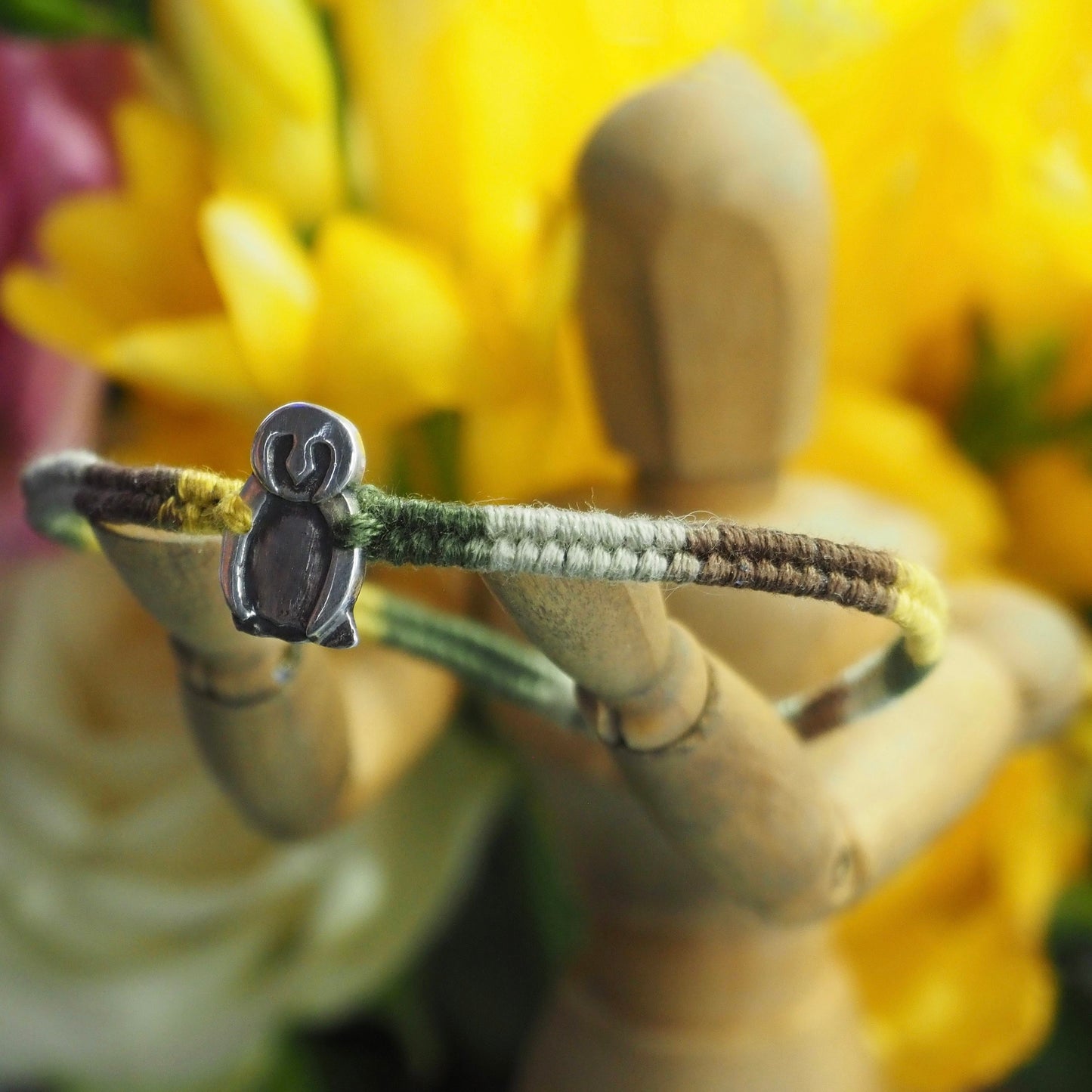 A lovely handmade fine silver owl on a soft browns and green leather, sterling silver and cotton friendship bracelet.