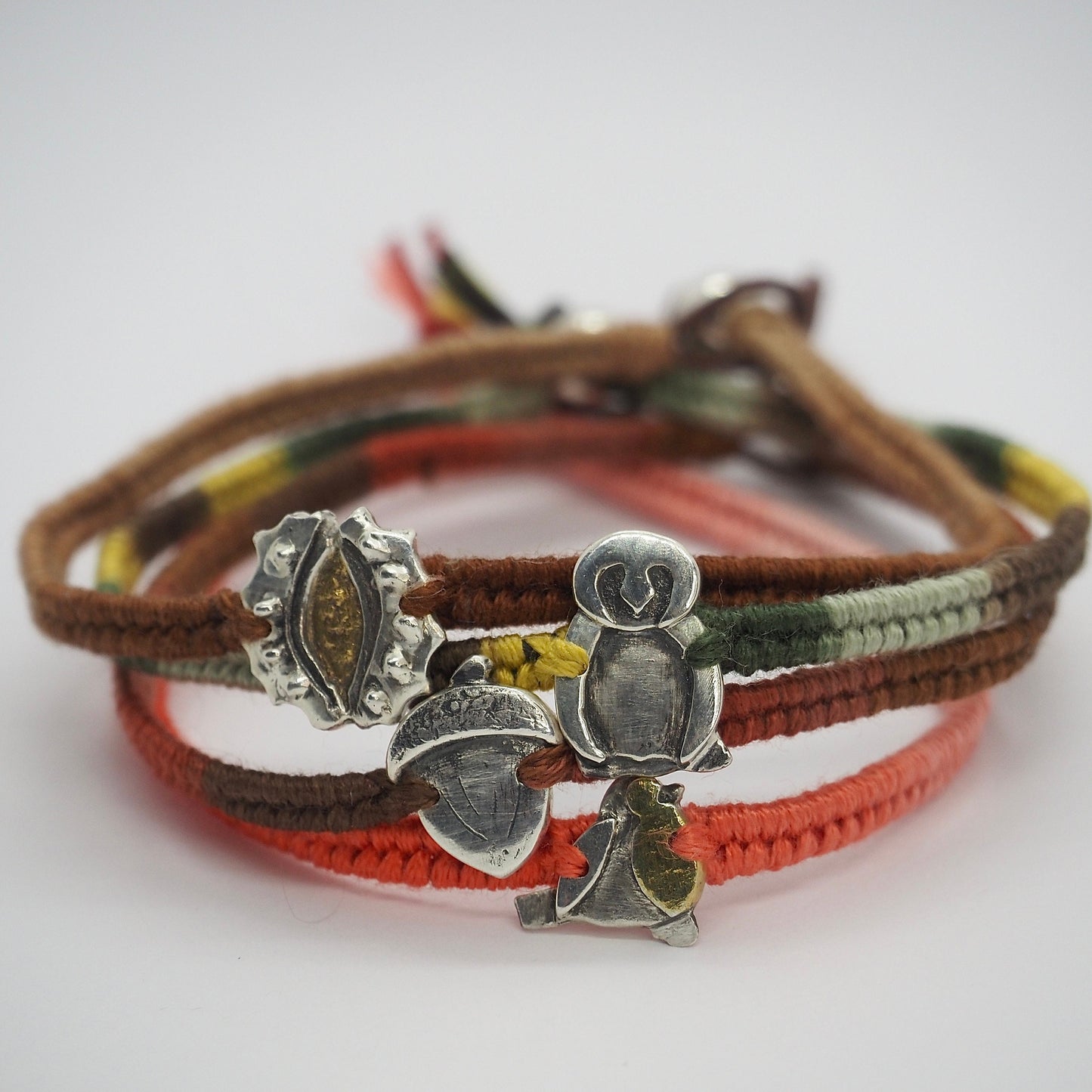 A lovely handmade fine silver owl on a soft browns and green leather, sterling silver and cotton friendship bracelet.