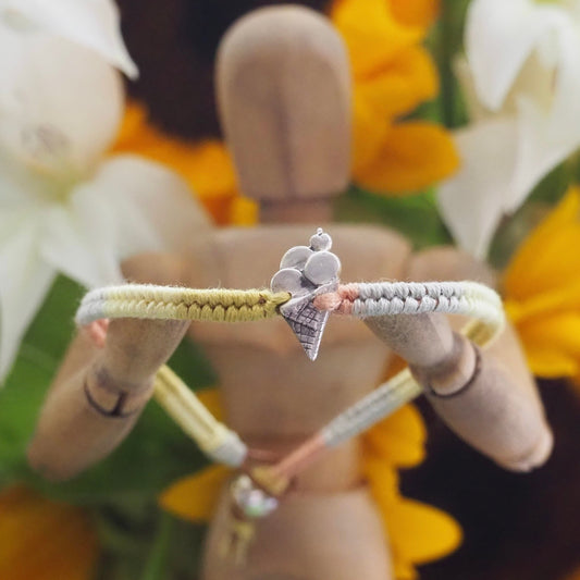 A cute little ice cream in handmade in fine silver on a peachy pinks leather, sterling silver and cotton friendship bracelet.