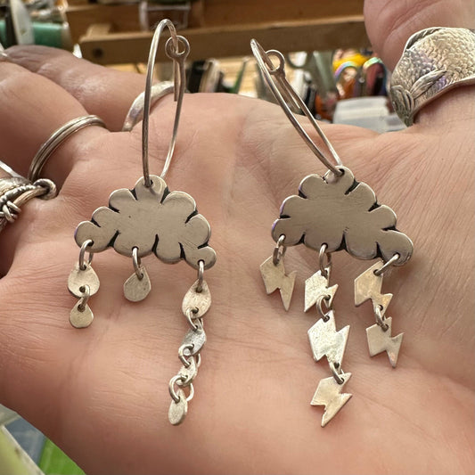 A delightful pair of cloudy weather earrings handmade in fine silver and hung on large handmade sterling silver hoops.