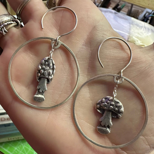 A gorgeous pair of toadstool earrings handmade in fine silver and hung on large handmade sterling silver hoops and wires…