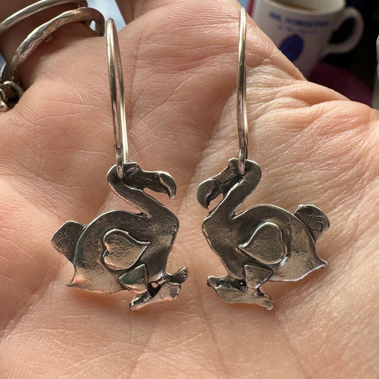 A gorgeous pair of midsize handmade fine silver dodo earrings hung on sterling silver wires.