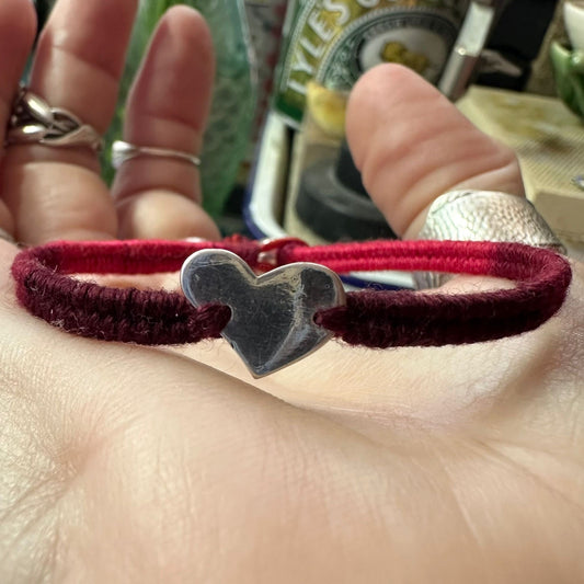 A fabulously blood red leather, sterling silver and cotton friendship bracelet with a tiny unique fine silver heart.