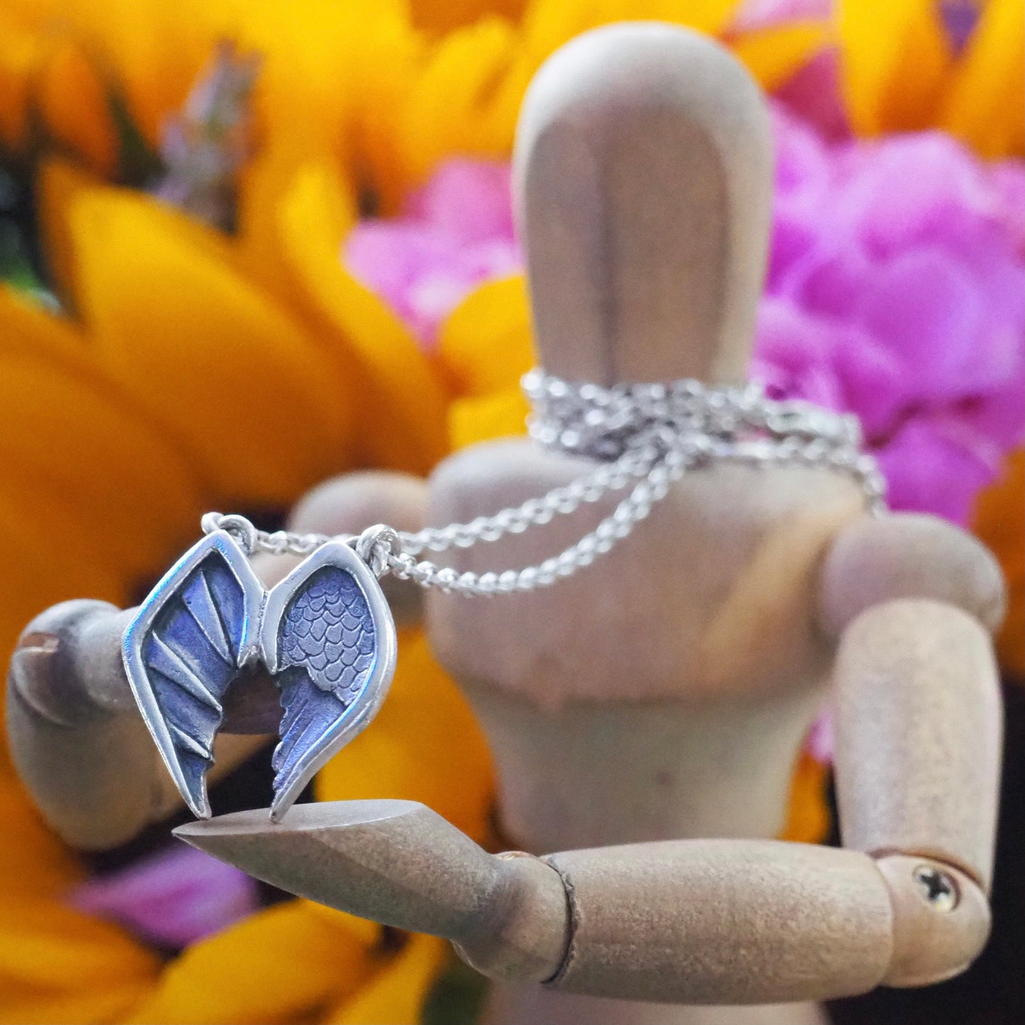 A pair of gorgeous fine silver angel and devil wings pendant on a sterling silver chain.